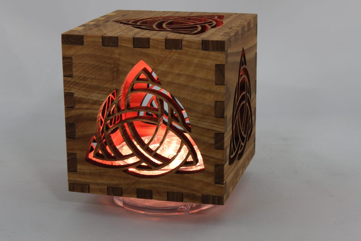 Finger-jointed wooden lantern box with a glowing laser-cut Celtic knot
